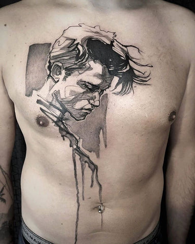 man portrait watercolor tattoo on the chest