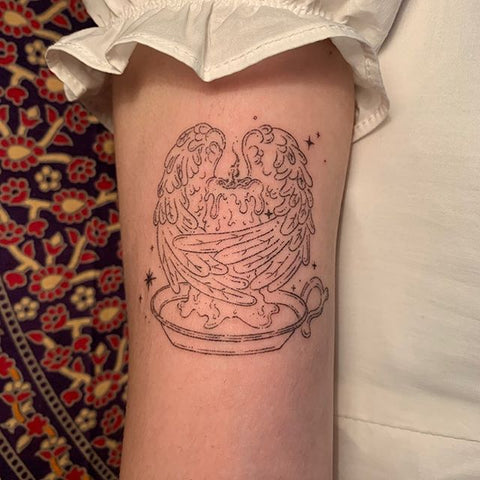 candle with wings tattoo
