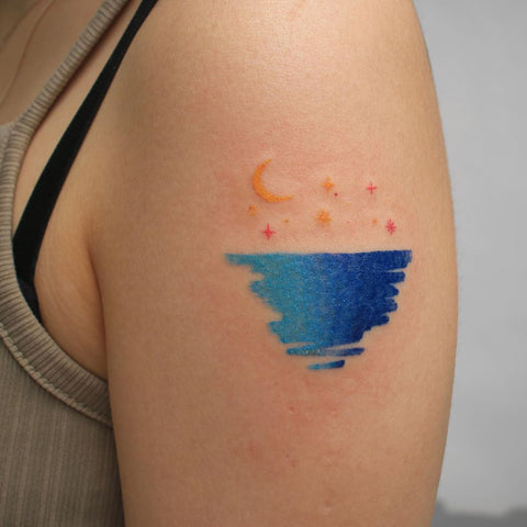 moon and star ocean sea tattoo on arm