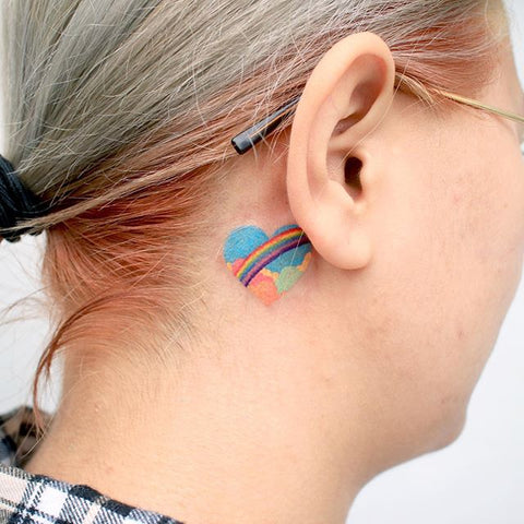 rainbow heart tattoo beind the ear