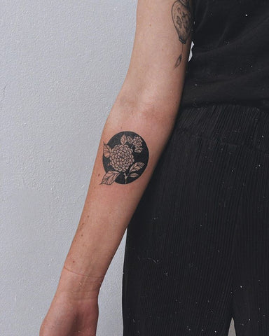 circular frame flower tattoo