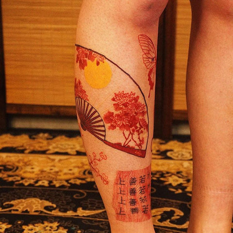 red fan Chinese character leg tattoo