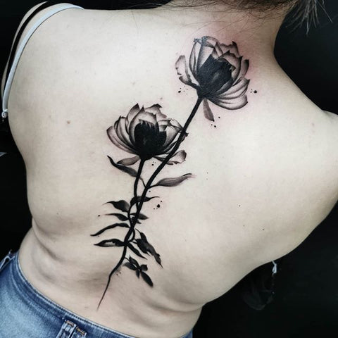 black flower back tattoo