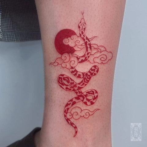 red snake leg tattoo