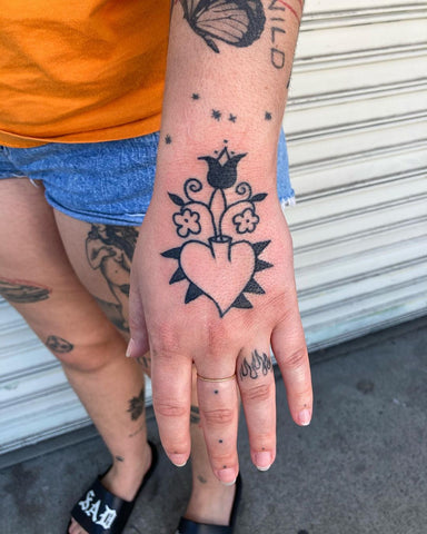 heart flower tattoo on the back of the hand