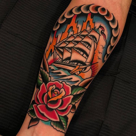 sail ship flower old school arm tattoo