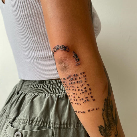 elbow word tattoo