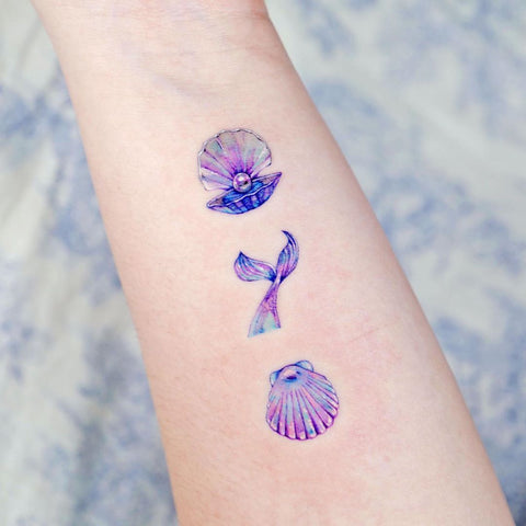 purple blue seashell conch fish tail forearm tattoo design