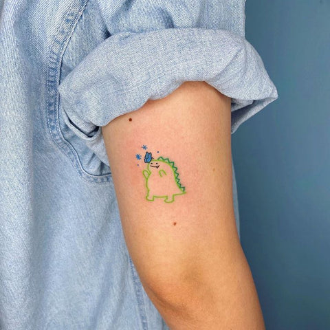 small green line dinosaur arm tattoo