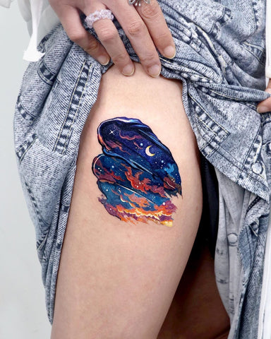 colorful paint night sky thigh tattoo