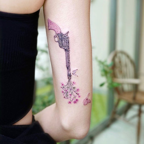 pink bulldog pistol tattoo with flower
