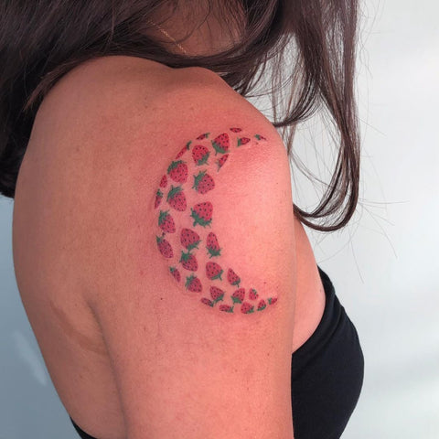 strawberry moon tattoo on shoulder