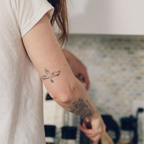 simple bird arm tattoo