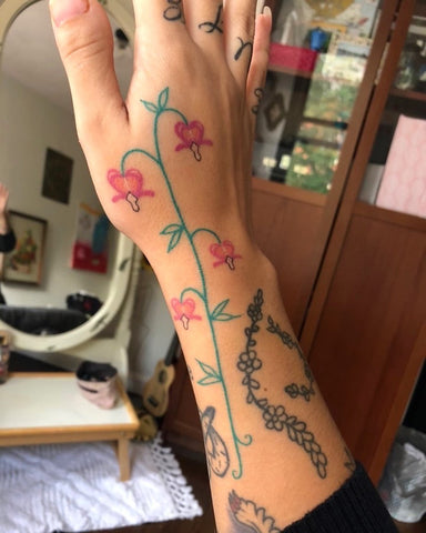 flower tattoo on the back of the hand and wrist