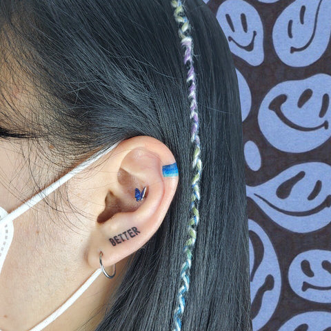 butterfly and word ear tattoo