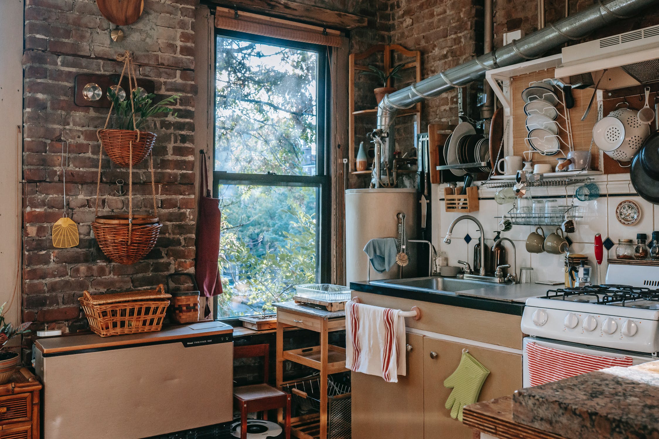 Country style Kitchen：Wooden 3 Layers Shelves With Drawer and Basket to Storage More Things,Brown Yellow Side Table Decorated by Wooden，and Different Baskets Maded by Common Wood, Concrete And Brick， and Different Decorations to Beautify The Kitchen