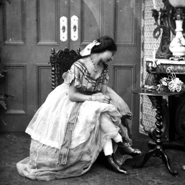 high-class lady in victorian era sitting on a vintage slipper chair