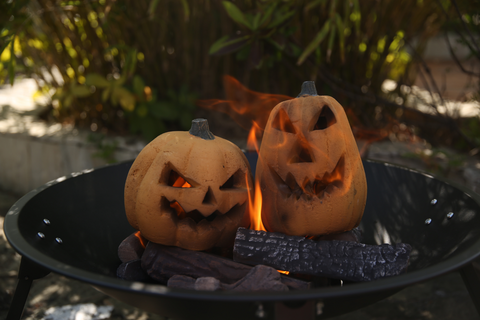 one taller& one round ceramic fiber pumpkin gas fireplace logs with 10pcs Large Ceramic Logs in an outdoor fire bowl.