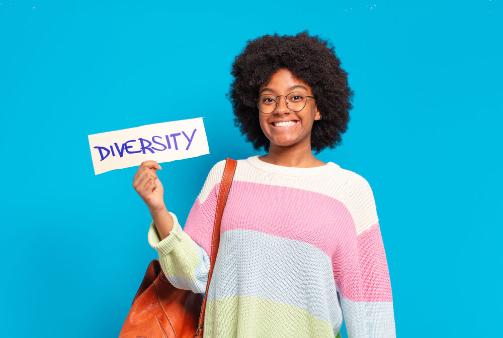 young pretty afro woman with afro kinky curly hair holding diversity card