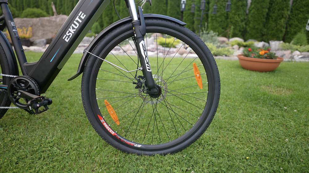 E-bike front wheel close-up on the grassland