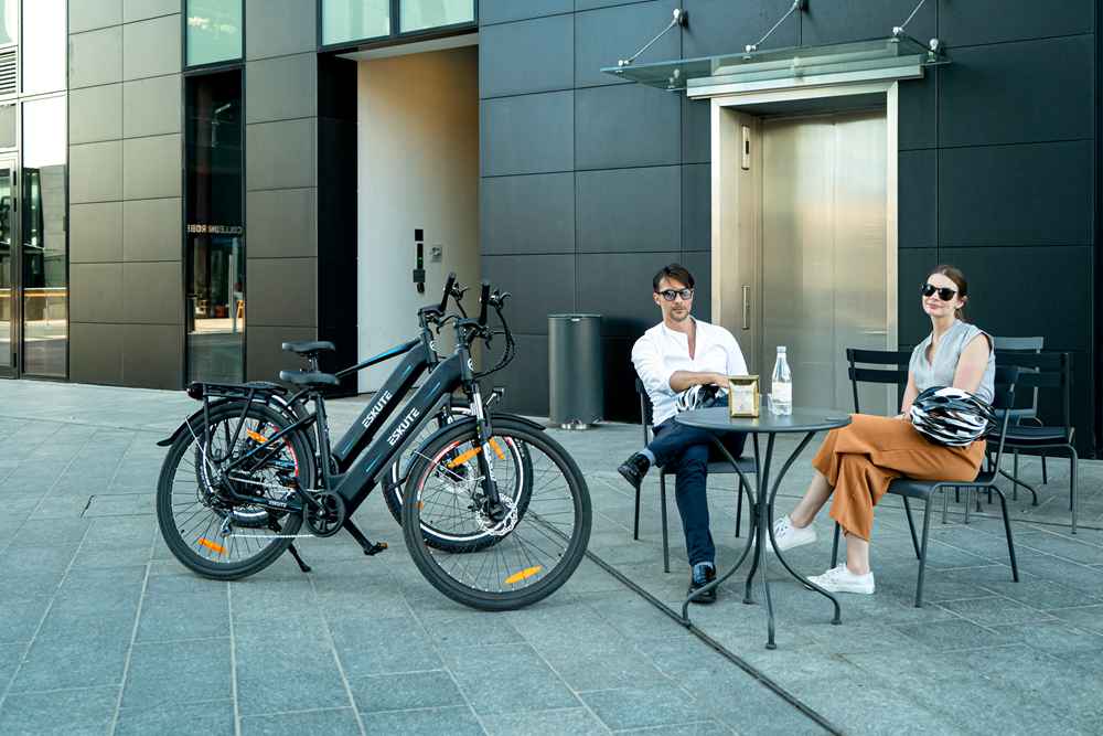 a man and a woman ride the best e bikes for commuting