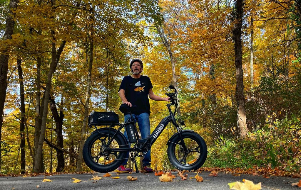 Man holding haoqi ebike standing