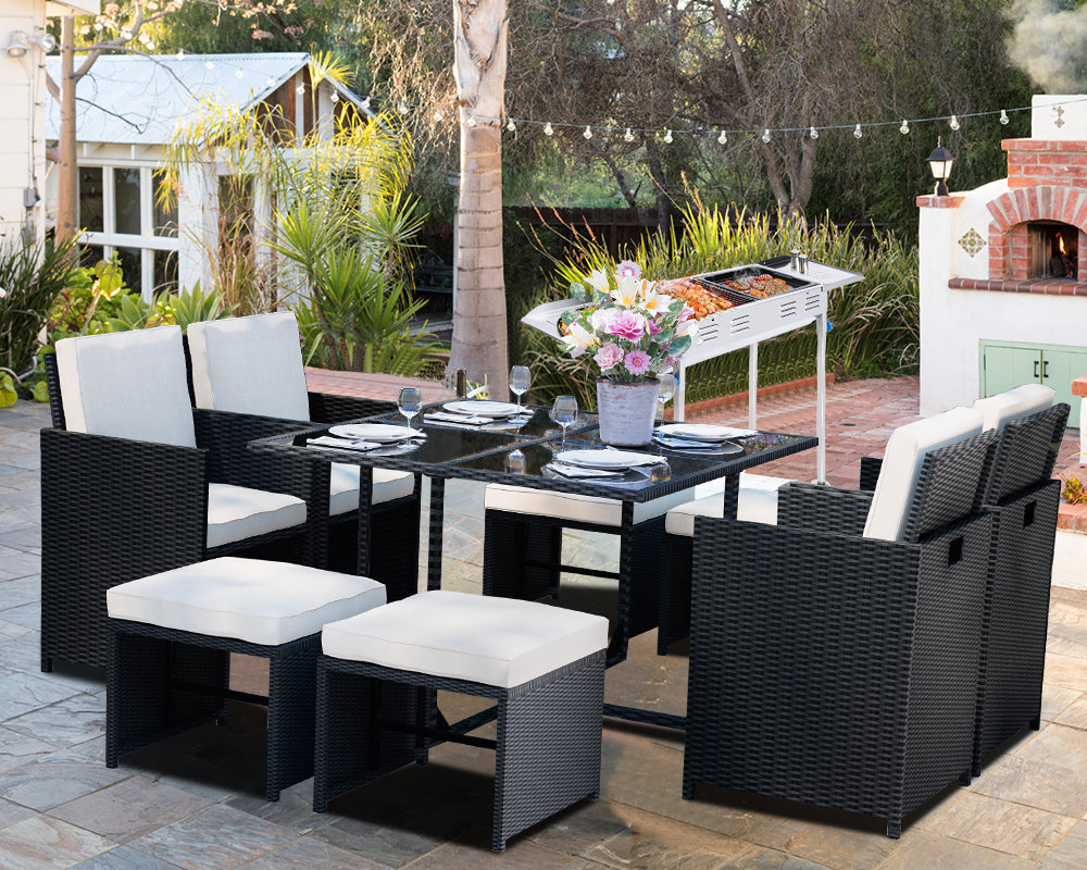 An Outdoor Kitchen with BBQ Grill and Rattan Furniture