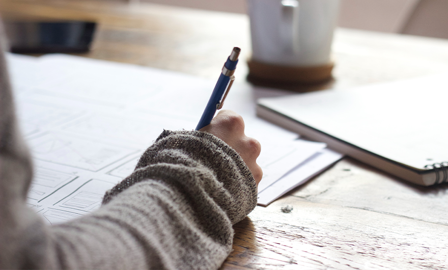 Right arm of a person studying at a desk