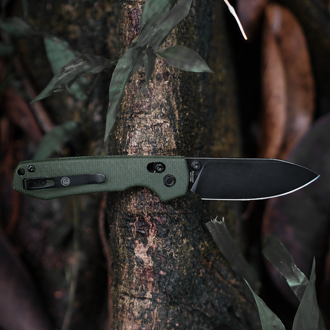 Outdoor EDC Folding Knife: A folding knife with a green G10 handle and black blade resting on a tree trunk, suitable for outdoor everyday carry
