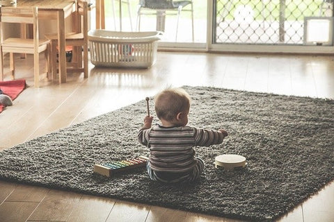 kids playing toys on mat at home
