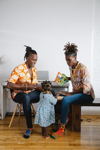 Parents playing building blocks together with children