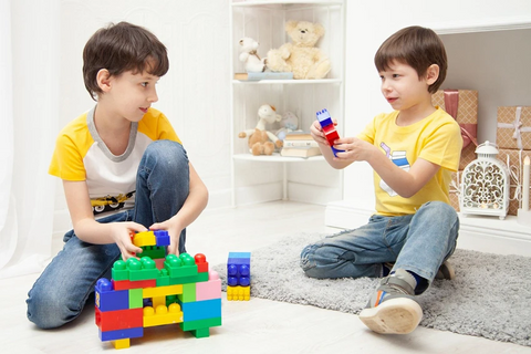 two kids are playing construction games