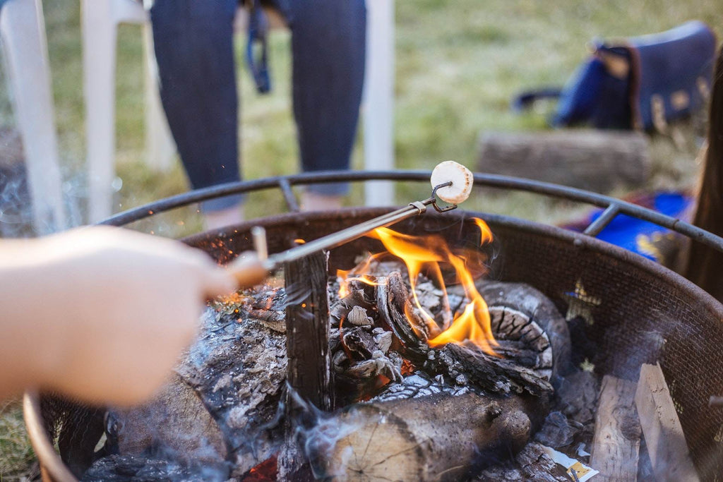 roasting marshmallow over campfire