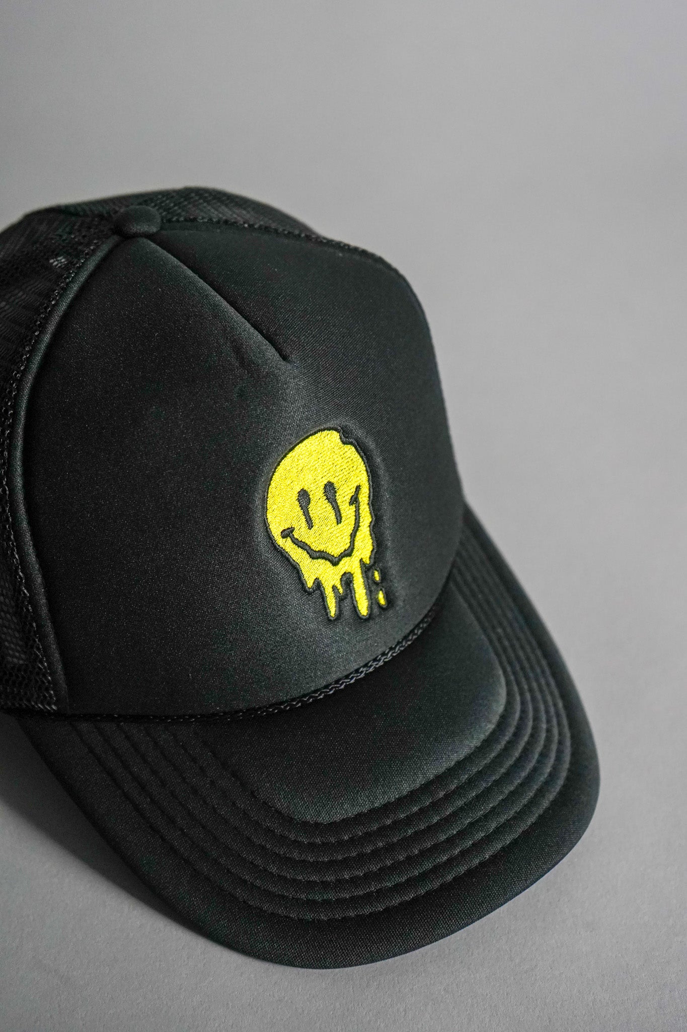 Melted Smiley Face Trucker Hat - Black