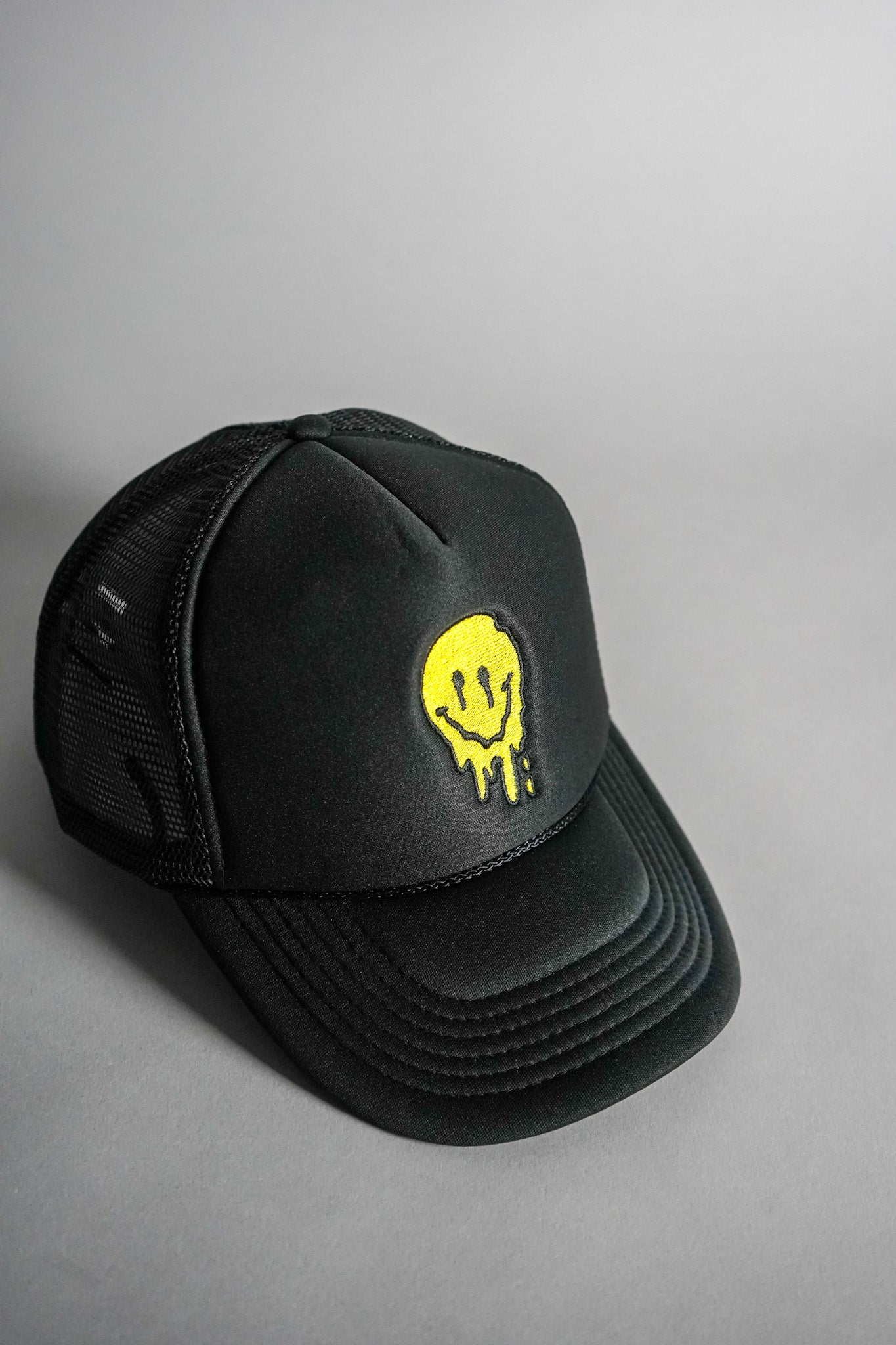 Melted Smiley Face Trucker Hat - Black