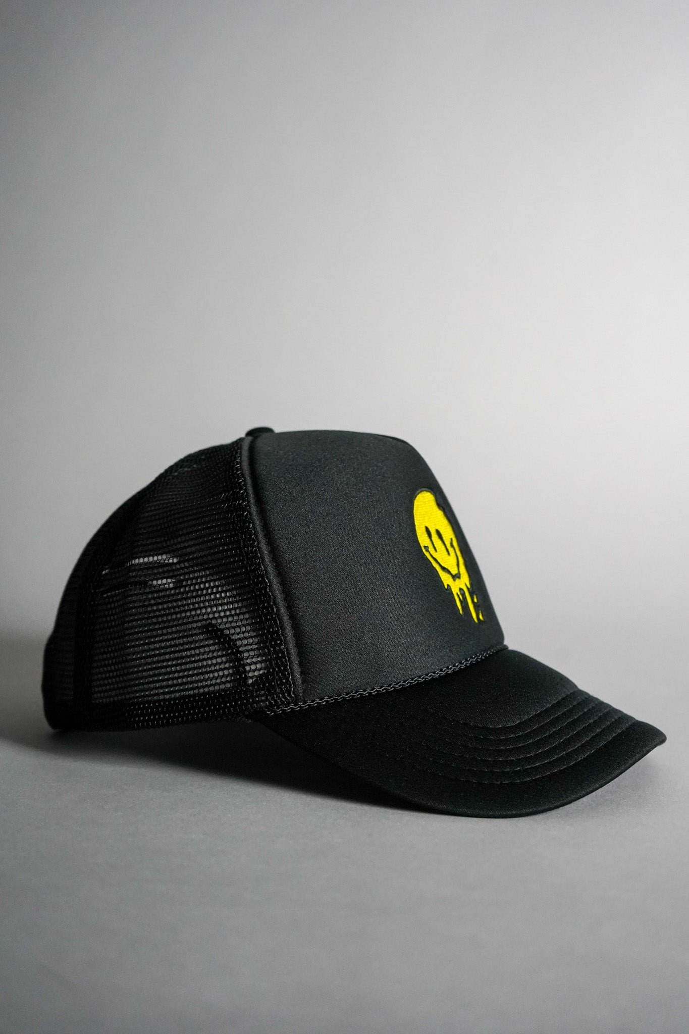 Melted Smiley Face Trucker Hat - Black