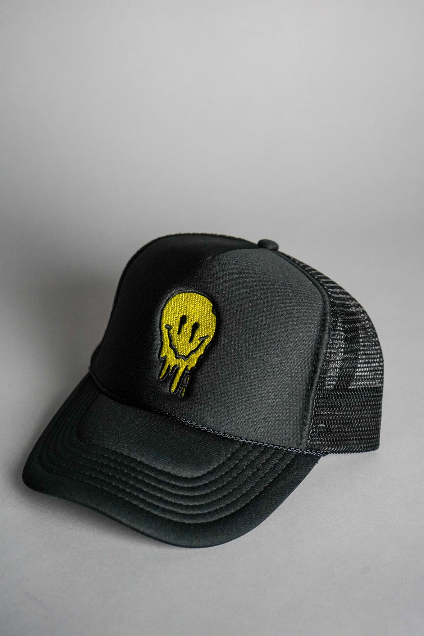 Melted Smiley Face Trucker Hat - Black