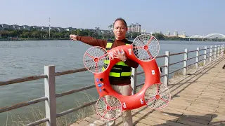 A middle-aged man holds the Watersaver TY-3R, a flying lifebuoy,water rescue drone