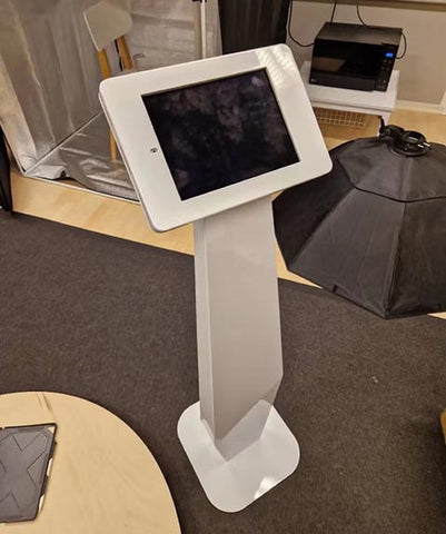 a white floor standing tablet stand