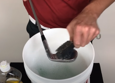 cleaning golf clubs
