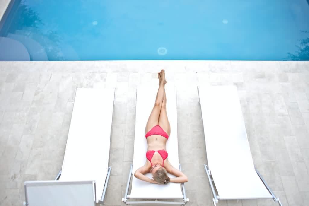 laser hair removal poolside girl lying on bench