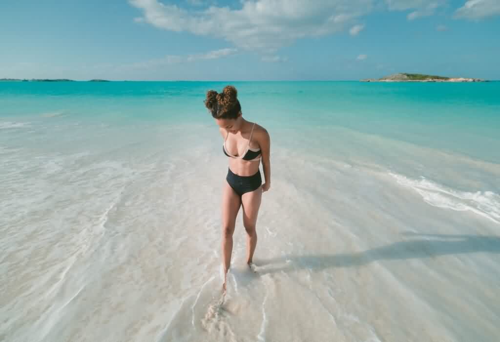 laser hair removal bikini girl splashing water on the beach