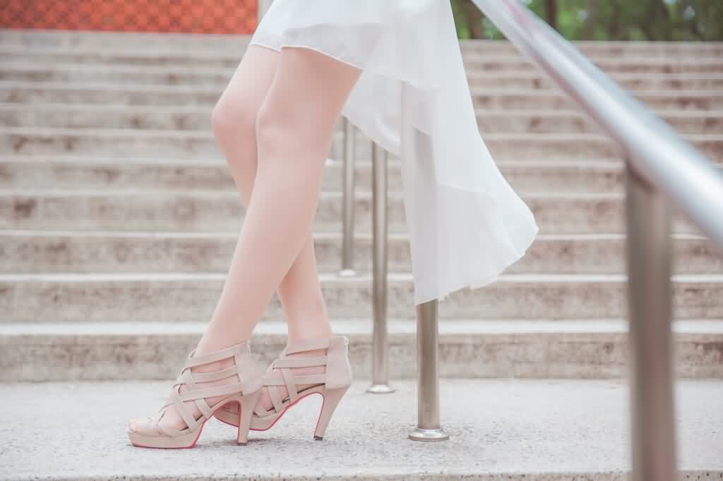woman with smooth legs leaning on hand rail