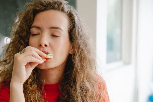 a woman is eating cookie