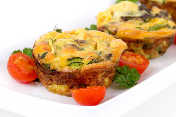 egg muffins on a plate with tomatoes