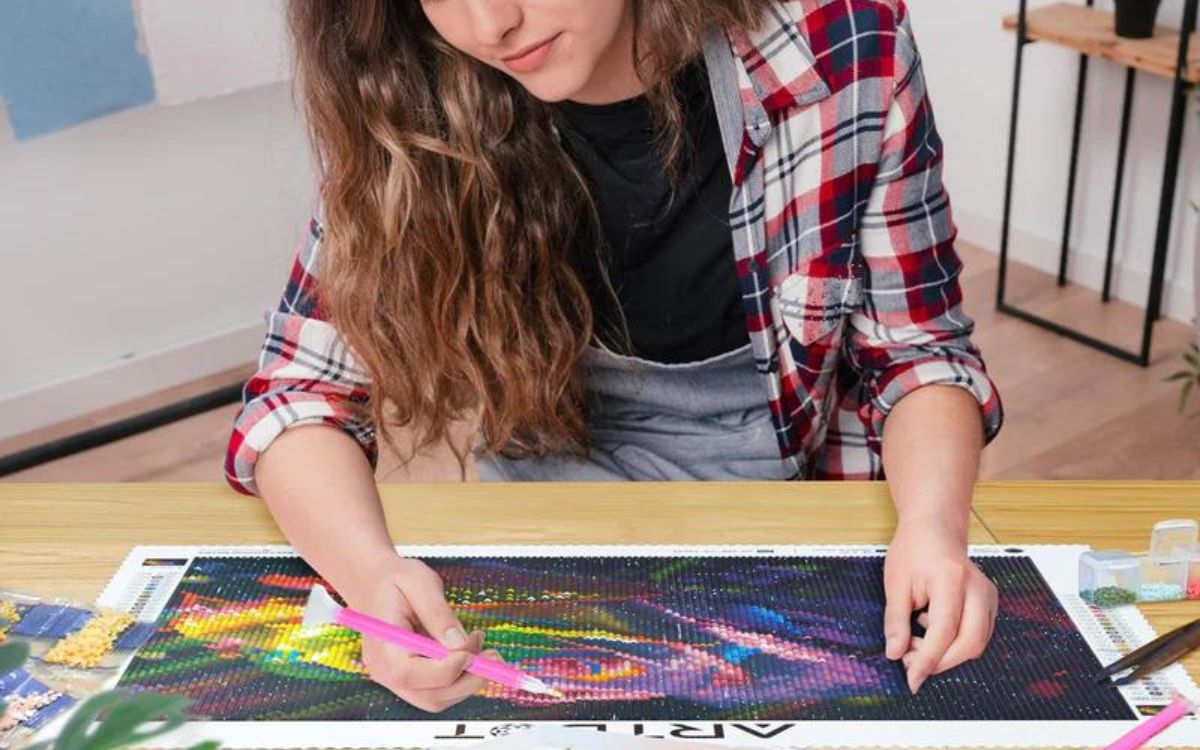 A woman is painting the Artdot's diamond art
