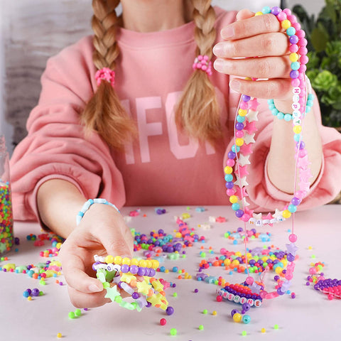 A girl is showing all the bracelets she made to us