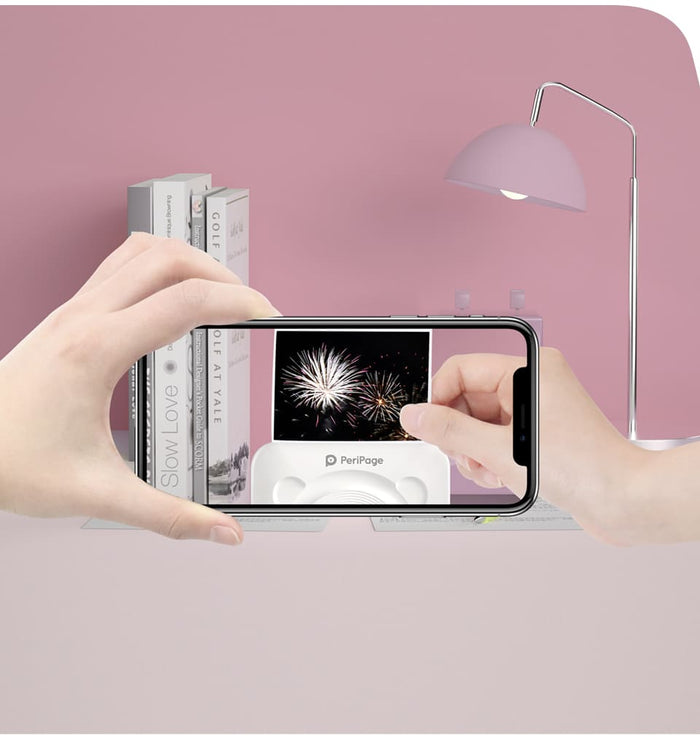 Person using a PeriPage mini printer to print fireworks photo from their phone