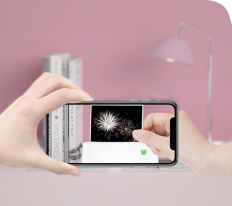Hands using PeriPage A9 Max mini printer to print a fireworks photo from smartphone, portable thermal printer for instant photo printing