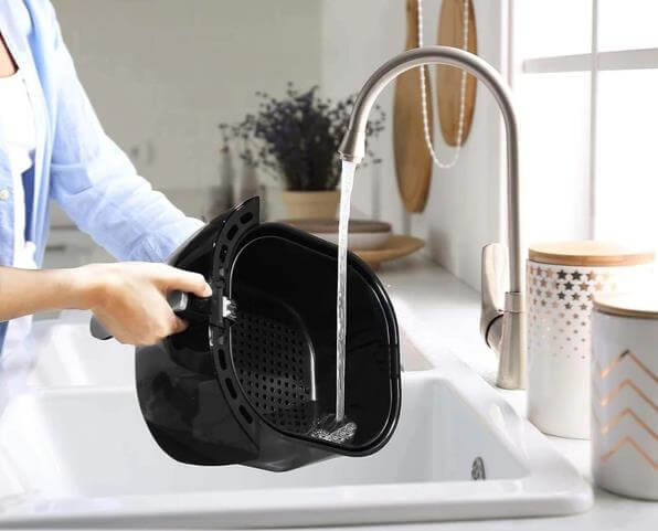 cleaning the basket of the air fryer